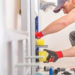 Person performing DIY with construction tools for bathroom remodeling by Green Hills Plumbing in an indoor setting.