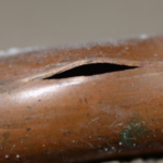 Close-up of a damaged wooden musical instrument, showcasing wear and cracks, linked to plumbing issues in Nashville.