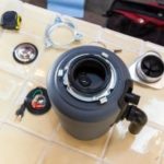 Turbocharger assembly with wiring and tools, showcasing engineering for plumbing services by Green Hills Plumbing.